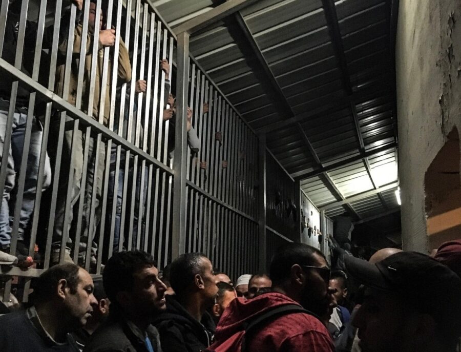 Palestinian commuters waiting at checkpoint 300