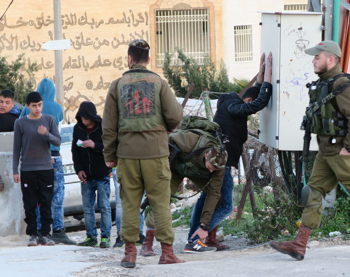 Israeli soldiers frisk Palestinian children in Hebron