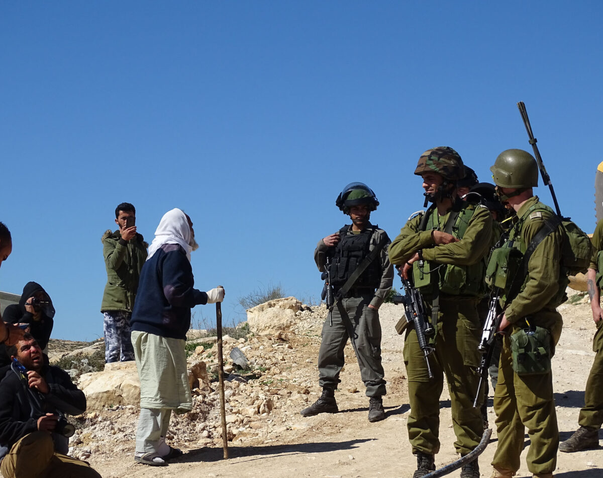 130219 A Palestinian shepherd complains to Israeli soldiers as community water pipes are destroyed