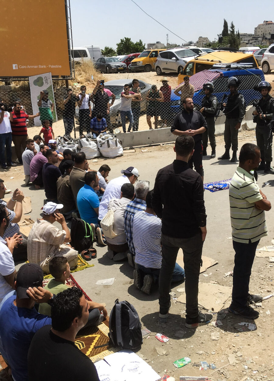 Palestinian muslims wait for worship