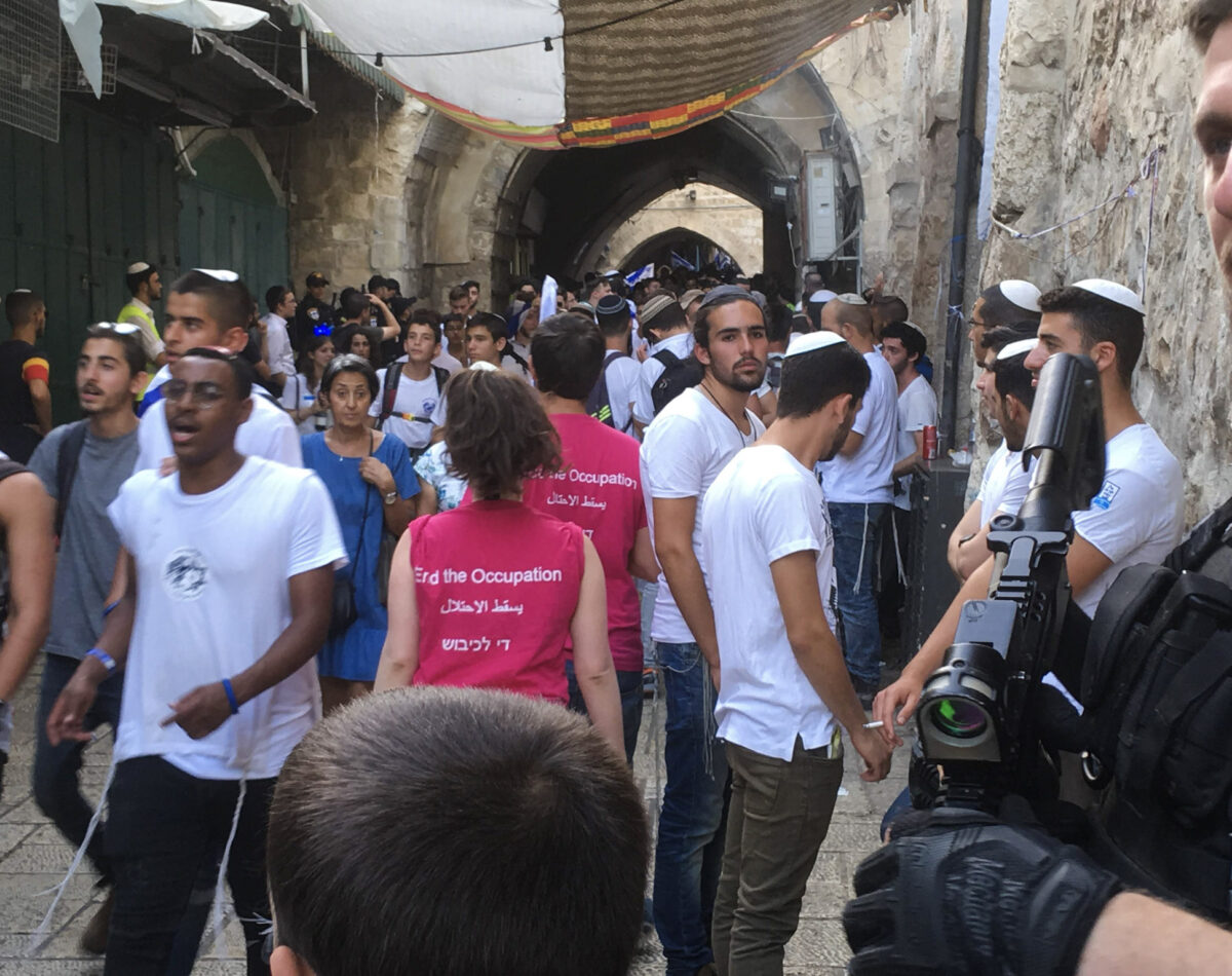 Israeli anti-occupation protestors pass the Jerusalem Day marchers