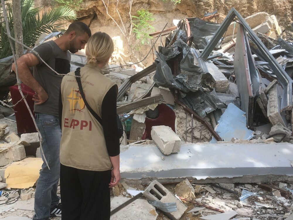 Qusai stands amidst the remains of his family home