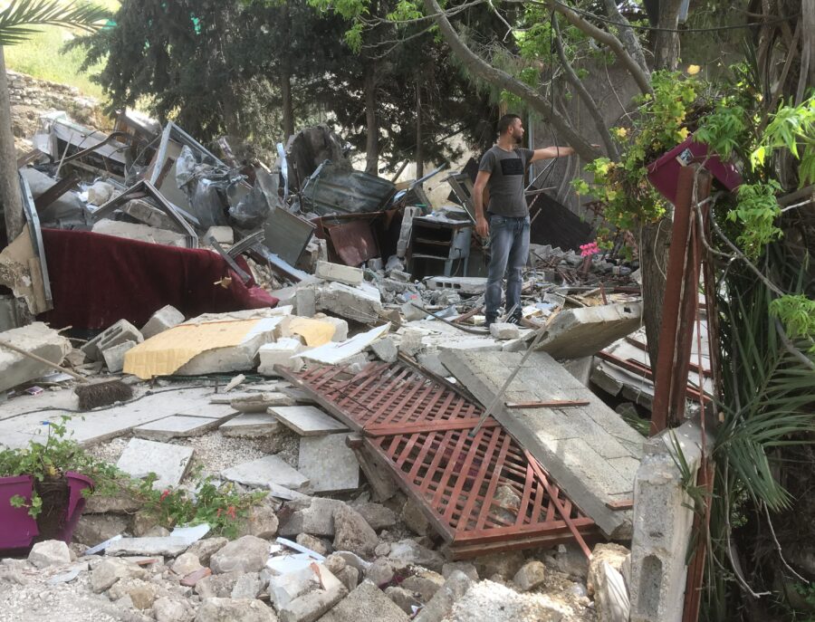 EA Annelie and a dejected Qusai near his demolished home