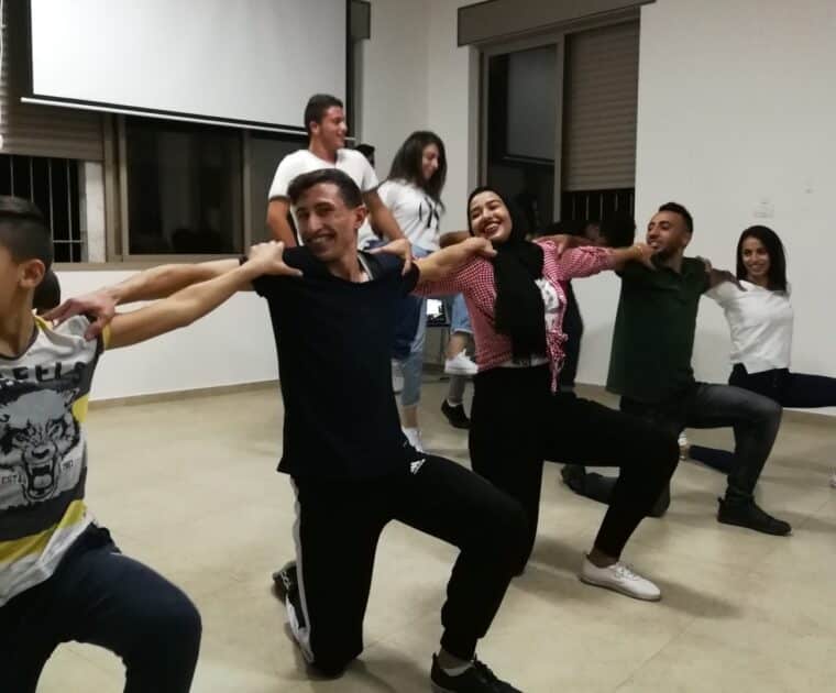 Dancersperforming traditional Dabke dance at the Alrowwad centre
