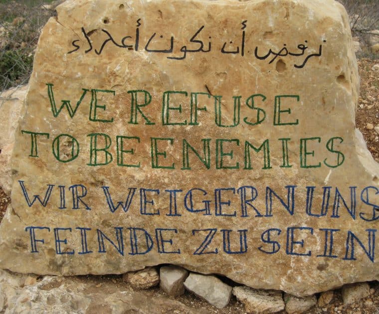 A plaque outside Tent of Nations reads 'we refuse to be enemies'