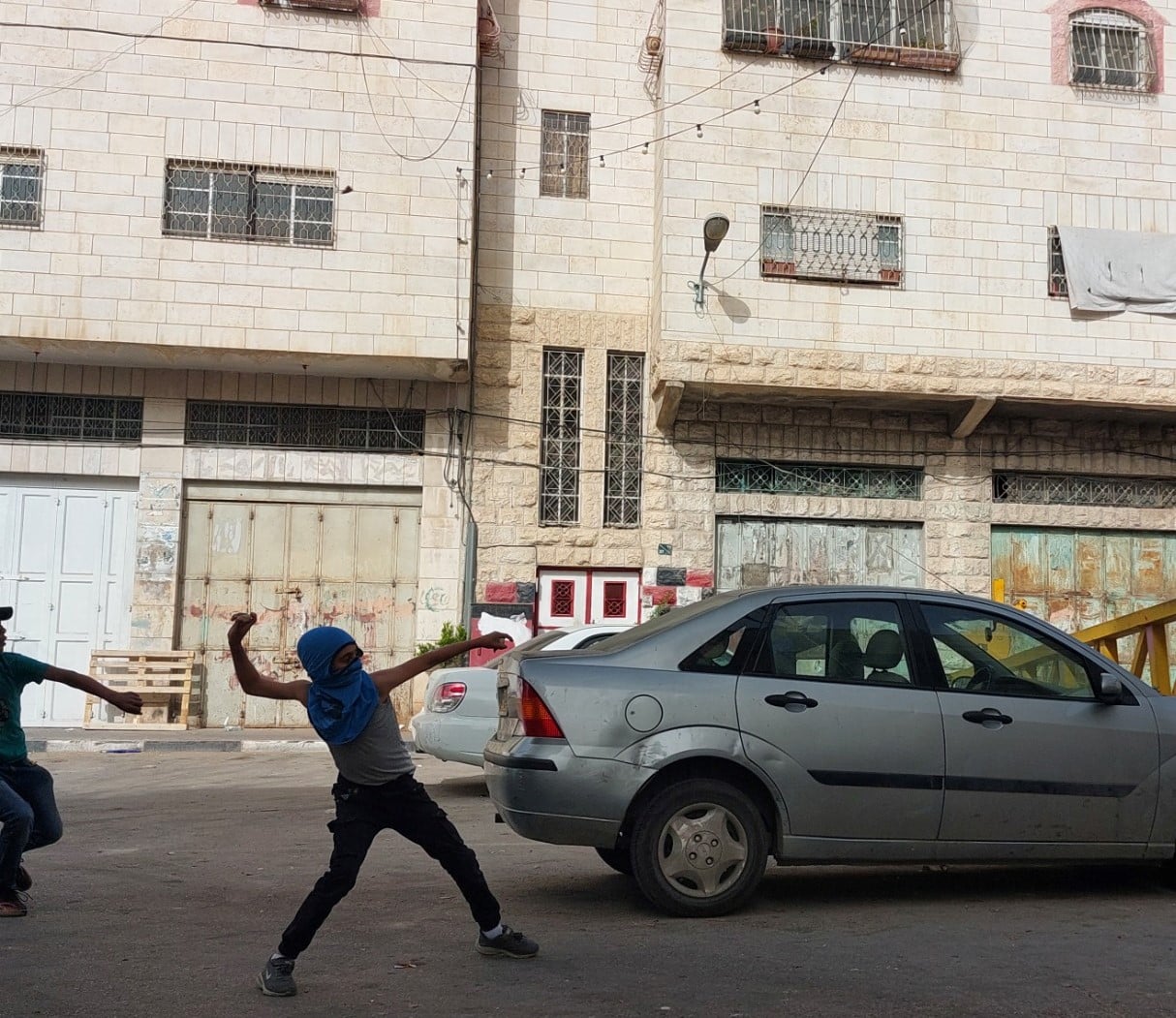 Young person throwing stones at Abu Rish checkpoint (2)