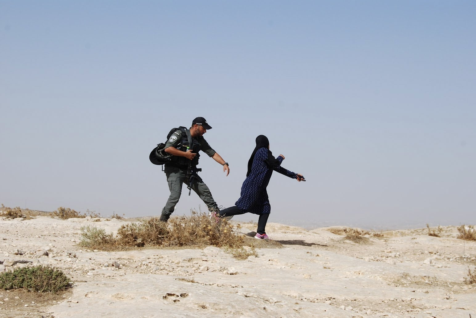 image Israeli soldier harrasses Palestinian family in their fields