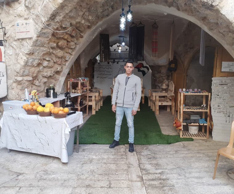 Ghandi outside his shop