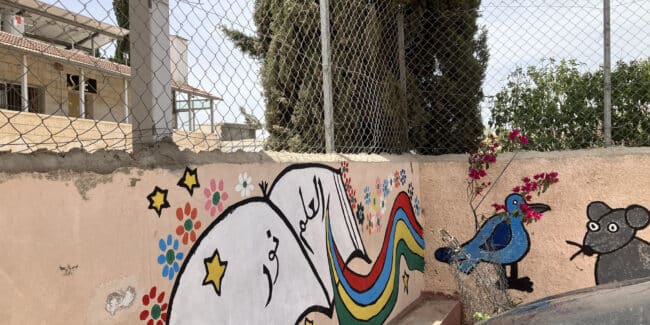 Wall at a Palestinian primary school with graffiti of a school book