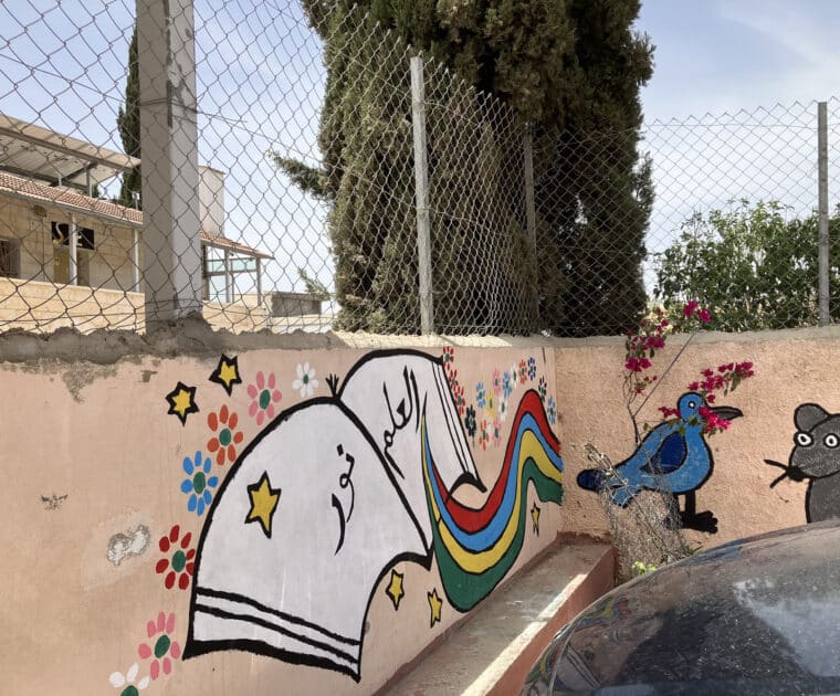 Wall at a Palestinian primary school with graffiti of a school book